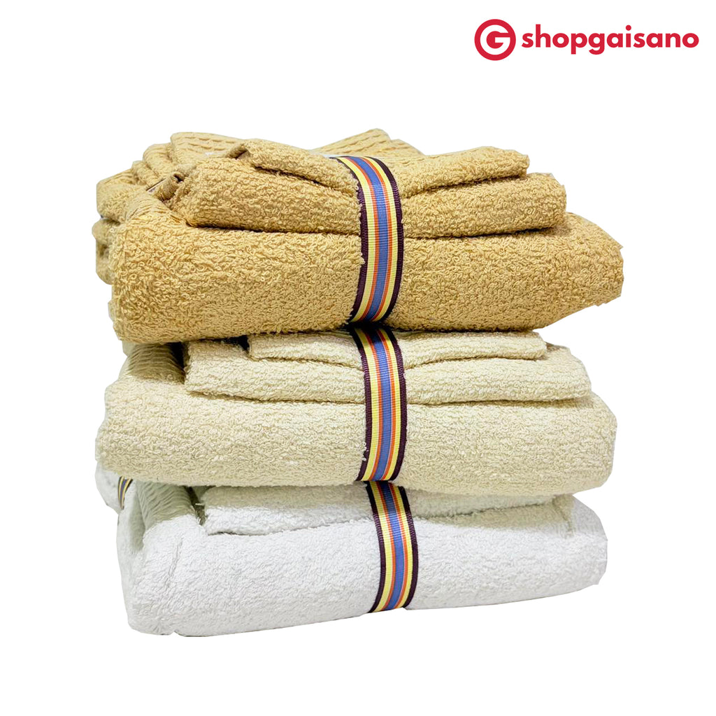 Three stacks of folded cotton towels in beige, cream, and white, each tied with a striped band featuring red, yellow, blue, and black stripes, on a white background with the ShopGaisano logo in the top right corner.